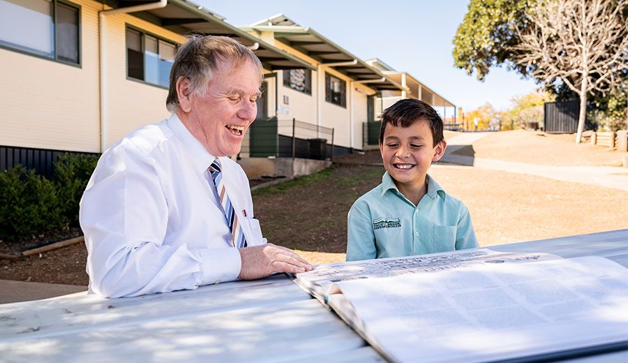 A junior school student chatting with the school chaplain
